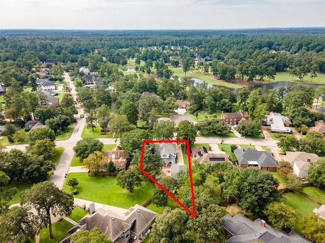 birds eye view of property featuring a view of trees, a residential view, and a water view