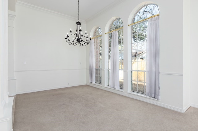 unfurnished dining area featuring crown molding, carpet flooring, a notable chandelier, and baseboards