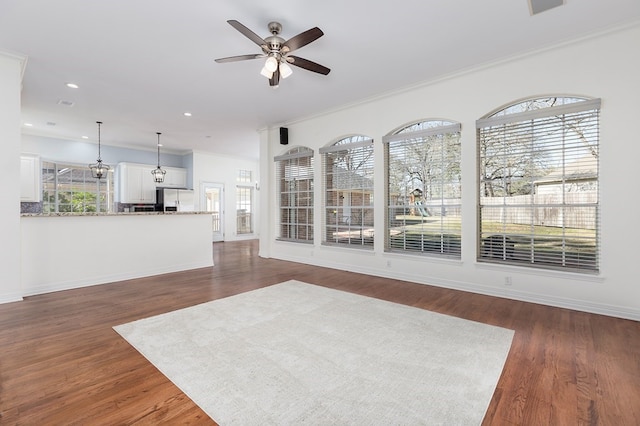 unfurnished living room featuring dark wood-style flooring, ceiling fan, recessed lighting, and baseboards