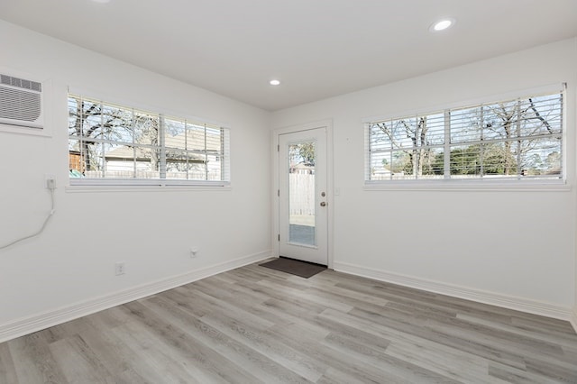 entryway featuring light wood-style flooring, recessed lighting, baseboards, and a wealth of natural light