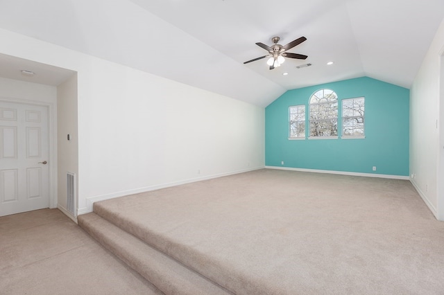 additional living space with baseboards, ceiling fan, light carpet, and lofted ceiling