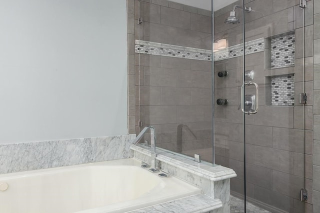 full bathroom with a stall shower and a garden tub