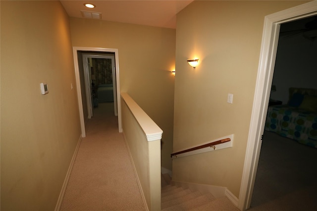 17 Regency Pt, Conroe, TX 77356 - hallway with visible vents, baseboards, an upstairs landing, and light carpet