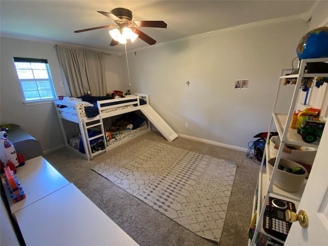 carpeted bedroom featuring ceiling fan, baseboards, and ornamental molding