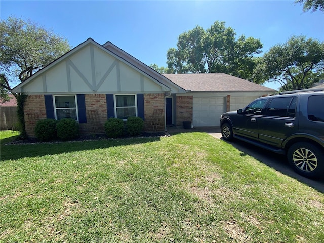 view of front facade featuring an attached garage, driveway, a front yard, and brick siding