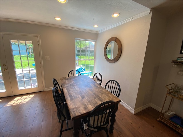 dining area with crown molding, wood-type flooring, baseboards, and recessed lighting