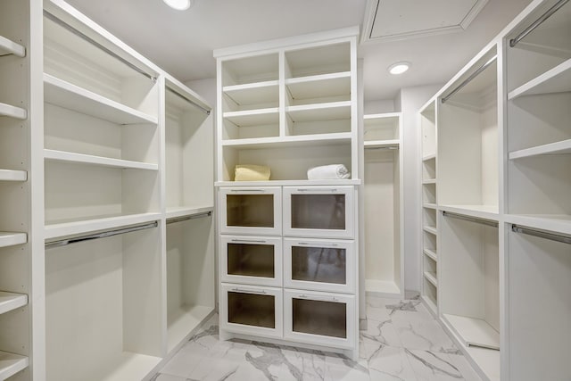 walk in closet with marble finish floor