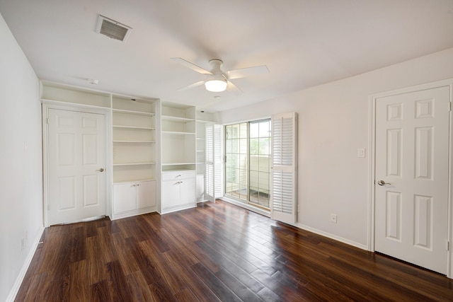 unfurnished bedroom with dark wood finished floors, visible vents, a ceiling fan, and baseboards