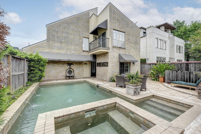 view of swimming pool featuring a patio, a fenced in pool, a fenced backyard, and an in ground hot tub