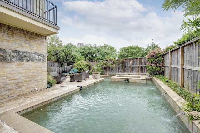 view of swimming pool with a pool with connected hot tub, a fenced backyard, and a patio area