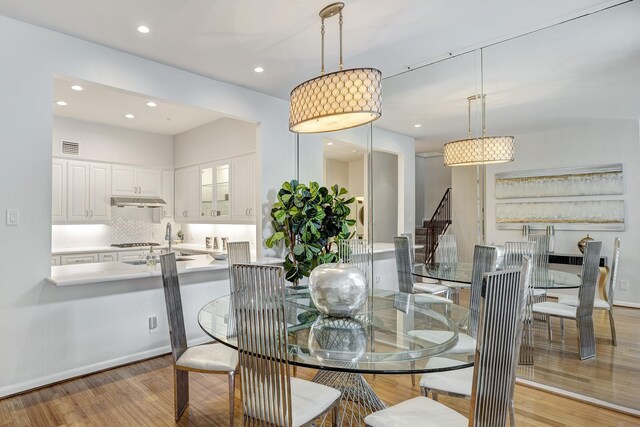 dining room with recessed lighting, visible vents, and light wood-style flooring