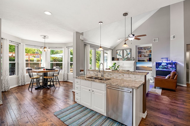 kitchen with dishwasher, a sink, dark wood-type flooring, open floor plan, and ceiling fan with notable chandelier