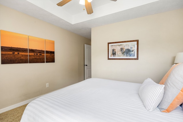 bedroom featuring carpet floors, a ceiling fan, and baseboards