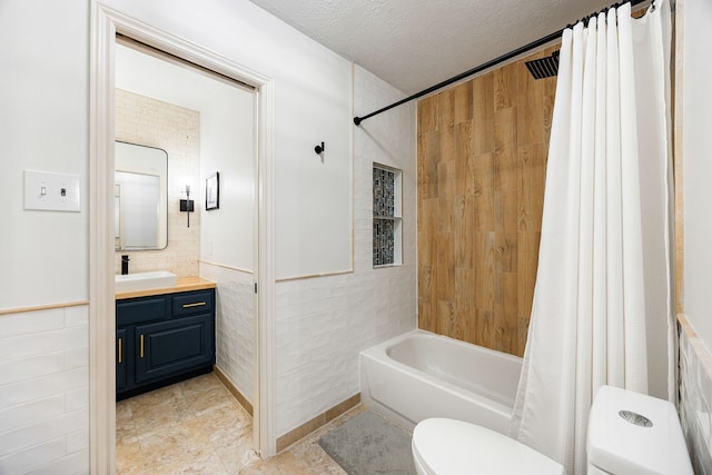 full bathroom featuring a textured ceiling, vanity, toilet, and shower / bath combo