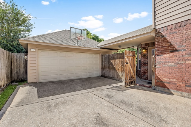 garage with fence and driveway