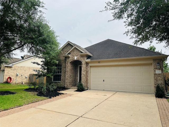 view of front of house featuring brick siding, driveway, a shingled roof, and a garage