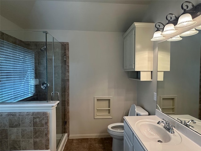 full bath with a shower stall, toilet, vanity, baseboards, and tile patterned flooring