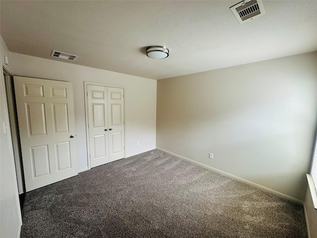 unfurnished bedroom featuring a closet, carpet, visible vents, and baseboards
