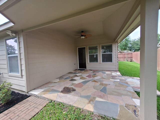 view of patio / terrace featuring ceiling fan and fence