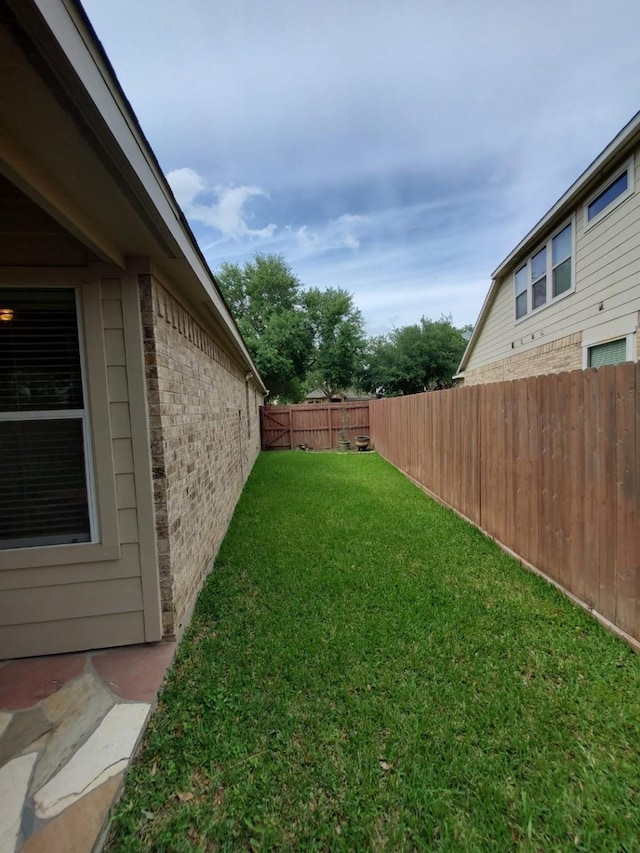 view of yard with a fenced backyard