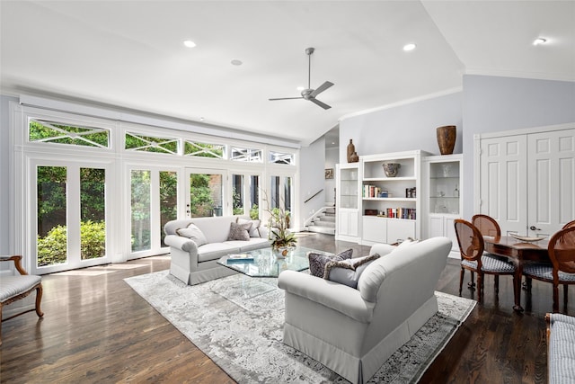 living room featuring plenty of natural light, ornamental molding, and lofted ceiling