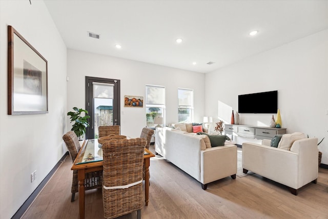 living area featuring visible vents, recessed lighting, and wood finished floors