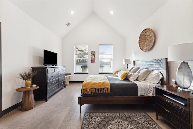 bedroom with high vaulted ceiling, light wood-type flooring, visible vents, recessed lighting, and baseboards