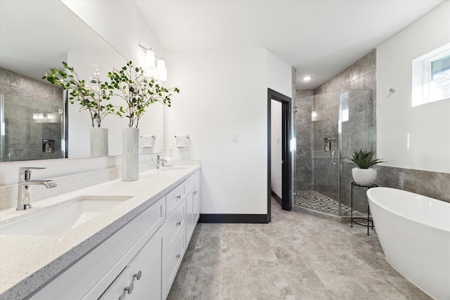 full bathroom with a shower stall, double vanity, a sink, and a soaking tub