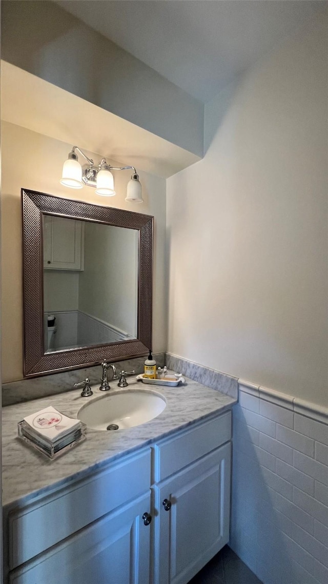 1809 Hawthorn Dr, Richmond, TX 77469 - bathroom with vanity, tile walls, and a wainscoted wall