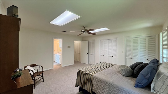 1809 Hawthorn Dr, Richmond, TX 77469 - bedroom with visible vents, baseboards, two closets, a skylight, and light carpet