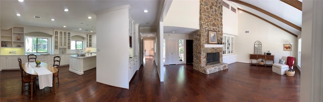 1809 Hawthorn Dr, Richmond, TX 77469 - kitchen with a stone fireplace, recessed lighting, white cabinets, dark wood-type flooring, and visible vents