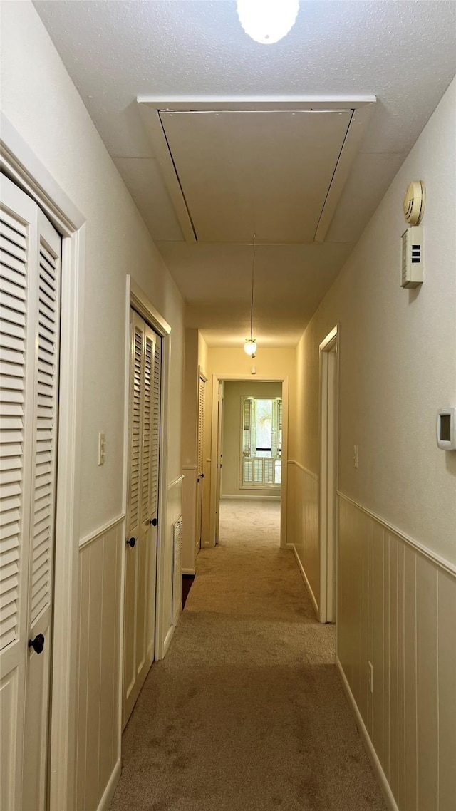 1809 Hawthorn Dr, Richmond, TX 77469 - corridor featuring attic access, carpet, and a wainscoted wall