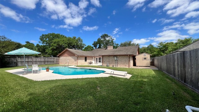 1809 Hawthorn Dr, Richmond, TX 77469 - view of pool with a patio, an outdoor structure, a storage shed, a fenced backyard, and a lawn