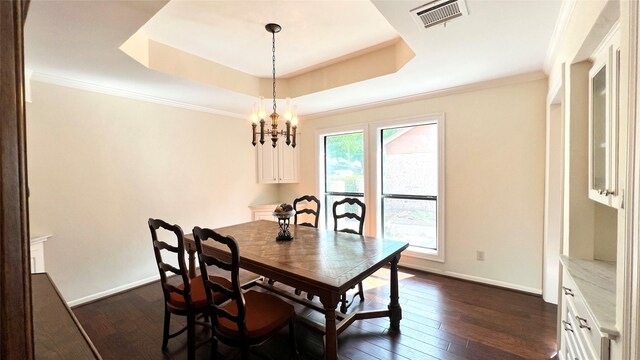 1809 Hawthorn Dr, Richmond, TX 77469 - dining area with visible vents, a chandelier, dark wood-style flooring, a raised ceiling, and baseboards