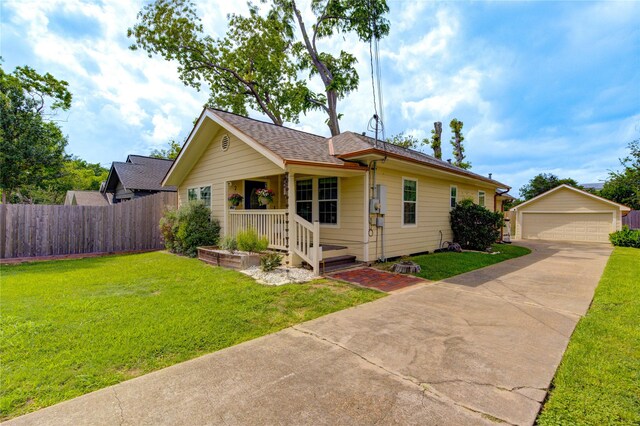 view of front facade featuring an outdoor structure, a garage, a porch, and roof with shingles