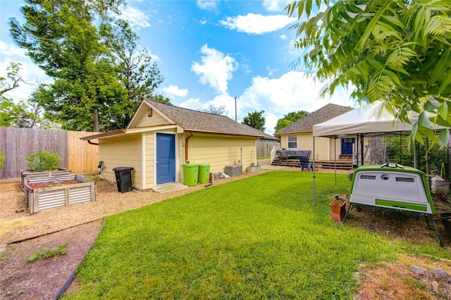 view of yard with a gazebo, a vegetable garden, and an outbuilding