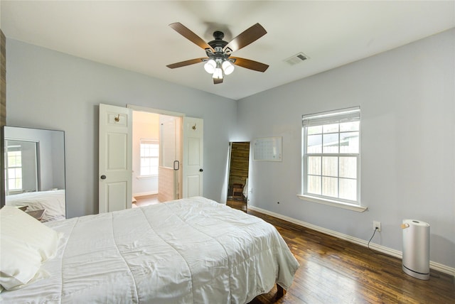 bedroom with dark wood-style floors, baseboards, and ceiling fan