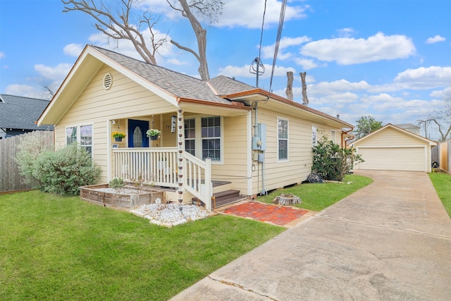 bungalow featuring an outbuilding, a detached garage, a porch, and a shingled roof