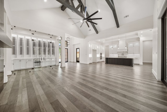 4458 Lily Bean, Montgomery, TX 77316 - unfurnished living room with beamed ceiling, high vaulted ceiling, ceiling fan, visible vents, and wood finished floors