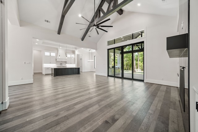 4458 Lily Bean, Montgomery, TX 77316 - unfurnished living room with beamed ceiling, baseboards, high vaulted ceiling, and wood finished floors