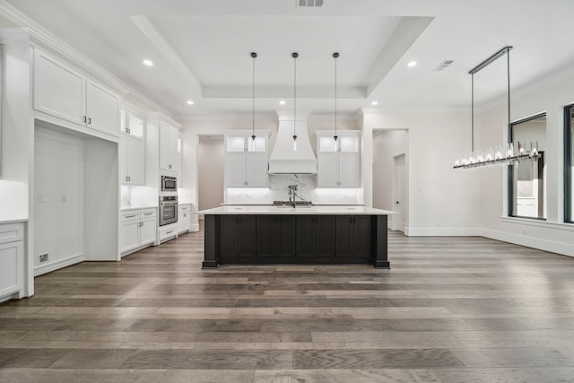 4458 Lily Bean, Montgomery, TX 77316 - kitchen with stainless steel oven, visible vents, custom range hood, and dark wood-style flooring
