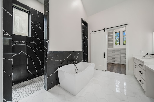 4458 Lily Bean, Montgomery, TX 77316 - full bathroom featuring tile patterned flooring, vanity, a walk in shower, tile walls, and a freestanding tub
