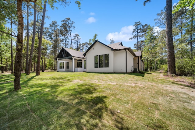 4458 Lily Bean, Montgomery, TX 77316 - rear view of property with central AC, stucco siding, and a lawn