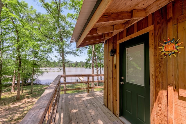 wooden terrace featuring a water view