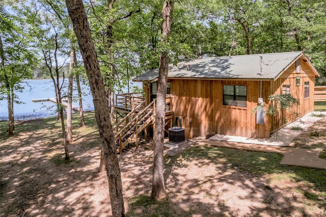 exterior space with an outbuilding, stairway, and central air condition unit