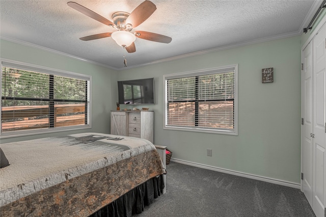bedroom featuring ornamental molding, dark carpet, baseboards, and a textured ceiling