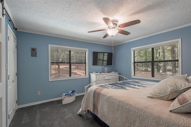 bedroom with baseboards, ceiling fan, a textured ceiling, crown molding, and carpet floors