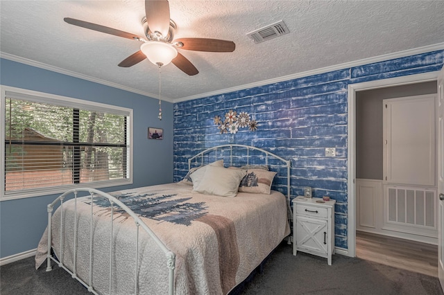 bedroom featuring a textured ceiling, wallpapered walls, visible vents, and carpet floors