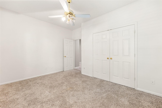 unfurnished bedroom featuring a ceiling fan, carpet floors, a closet, and baseboards
