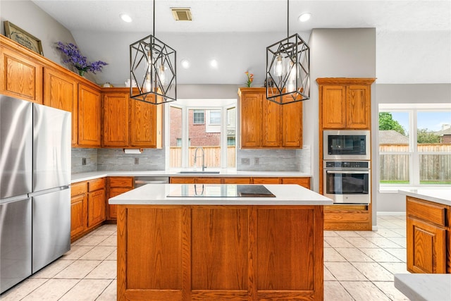 kitchen with a healthy amount of sunlight, visible vents, a sink, light countertops, and appliances with stainless steel finishes